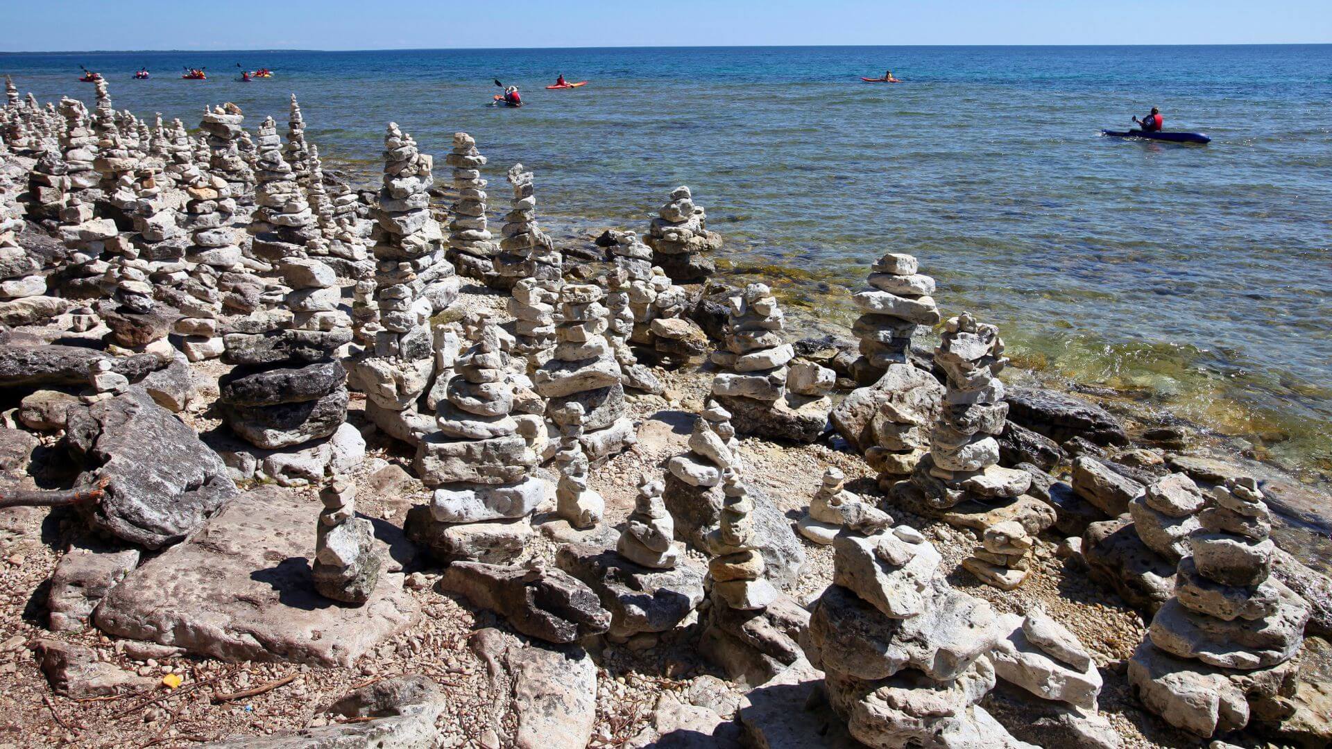 kaykers on rocky coastline of cave point state park in door county wisconsin