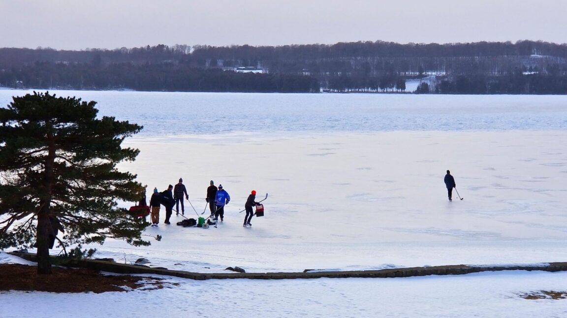 people playing ice hockey outside edgewater resort in ephraim wisconsin