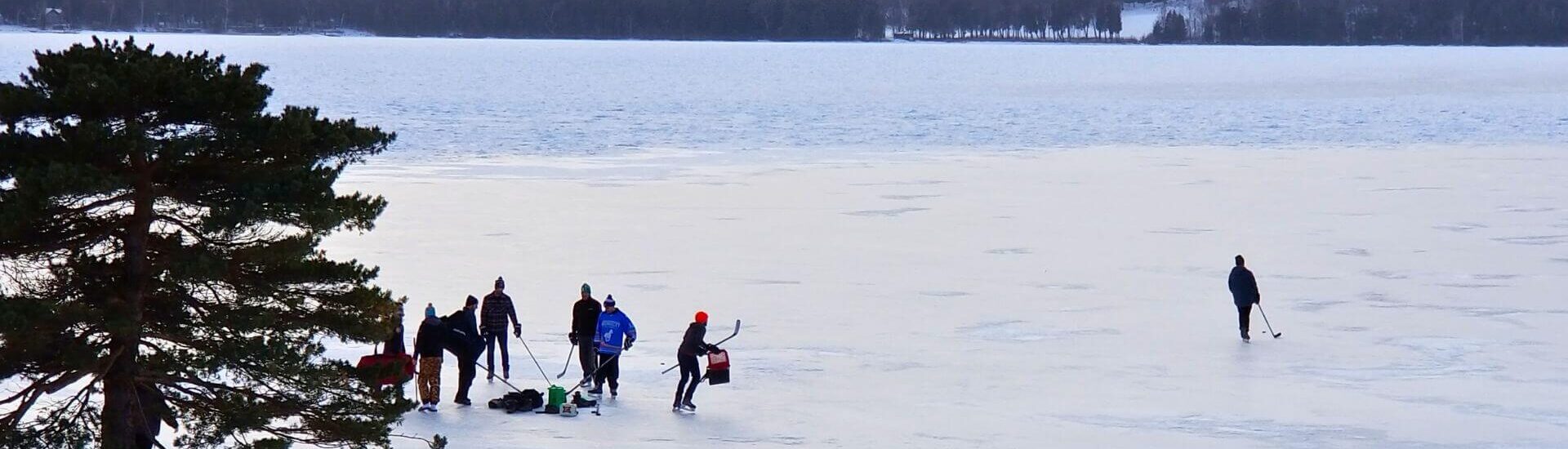 people playing ice hockey outside edgewater resort in ephraim wisconsin